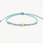 Pulsera De Oro Con Cilindros 5X7 Y Esferas Diamantadas Hilo Celeste